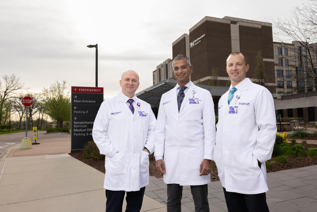 Physicians posing in front of a building