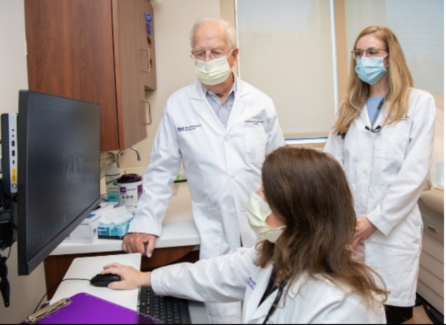 Physicians looking at a computer screen