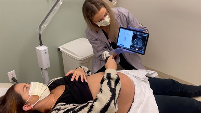 woman giving ultrasound with smartphone