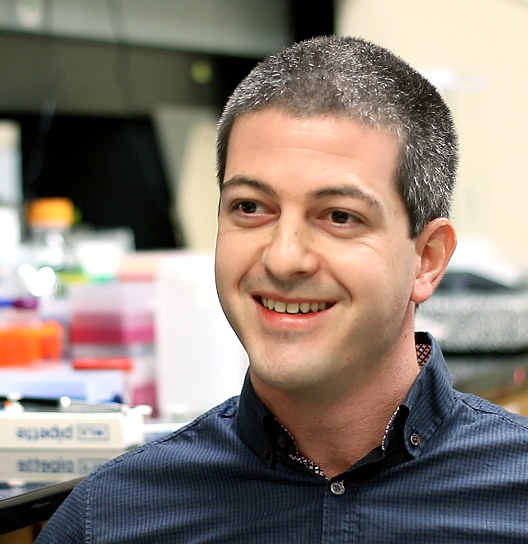 Gregory Schwartz, PhD smiling in a lab
