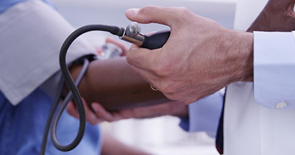 physician taking patients blood pressure