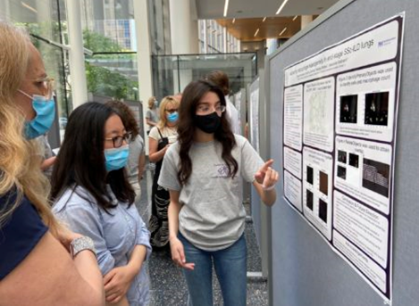 Image of students presenting their research posters. Courtesy of Sean Campbell.