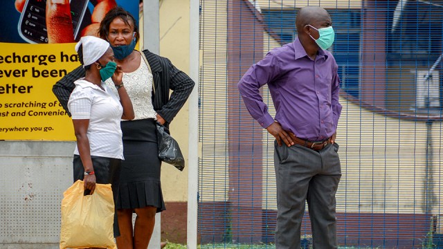 Masked people in street in Nigeria