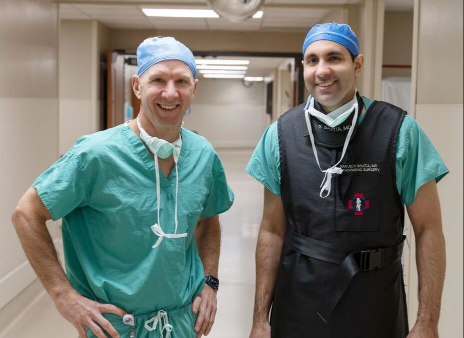 Michael David Stover, MD; ​Sanjeev Bhatia, MD standing in hallway