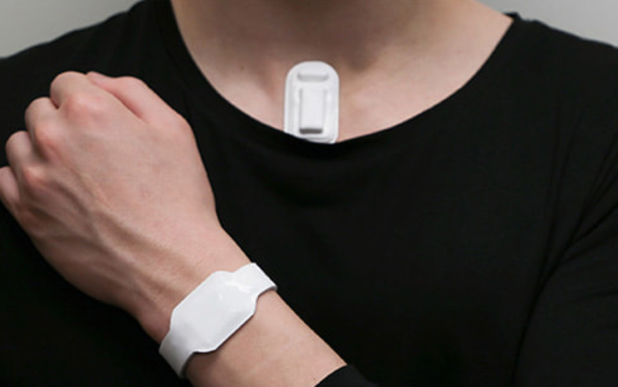 person with wearable device on wrist and neck