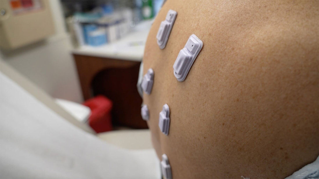 Persons stomach with wearables on it
